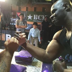 Rehearsing arm wrestling scene camera back right shoots Junior POV towards Beef Train played by costar Isaac C Singleton Jr Oct 2014 Ryan plays Horse Hoggs son Junior cast to be played by a girl for this parody film