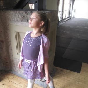 Ryan captures the look of a ballerina during a break at AMERICAN GIRL - Isabelle, Girl of the Year 2014 doll commercial (Dec. 2013). Ryan is actually a hip-hop dancer.