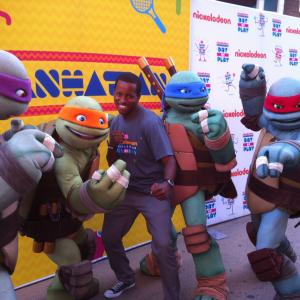 John Maurice Harris posing with the Ninja Turtles during Nickelodeons World Wide Day of Play event in Times Square September 2013