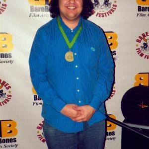 Raj Jawa at 15th Bare Bones International Film & Music Festival in Muskogee, OK wearing the medallion awarded to P.A. for Best Comedy Micro Short.