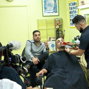 Alberto Delgado, Jr. chats with Moe the barber on how he wants to help Gerry better his life as they film an episode of the 