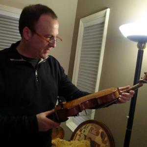 Bill Townsend inspecting a Stradivari violin for Treasure Detectives