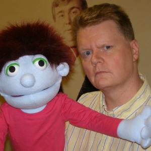 A trained puppeteer Randall is cowriter of SomeTV! a sketch comedy television program involving puppets and humans currently in production