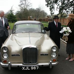 Filming WATERS END we see the real Lord Nigel Jones on leftplaying a chauffeur waiting for actor Peter Osborn The Lord saying goodbye to Maralyn Reynolds Mary Nigel had to drive the 1957 Alvis saloon with no powersteering hurting his back badly