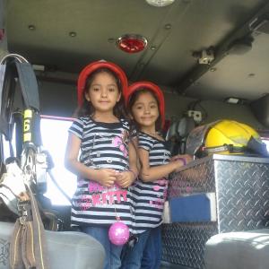 Nalena & Lavena hanging out in the fire truck during Vietnamese New Year 2014.