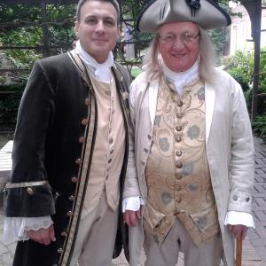 Noel Ramos portrays a Colonial Delegate, posing with Ben Franklin as they attend a meeting.