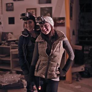 Katie Schurman and Jordan Streussnig smiling behind the scenes