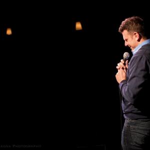 Anthony DeVries doing stand up in the darkest room on earth.