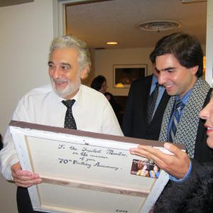 Mikael is presenting to Maestro Placido Domingo his portrait that he painted. November 6, 2011