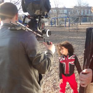 Still photo of actor Cruz Rodriguez on the set of The Cannonball Phone Application Web Commercial with actress mom  camera crew