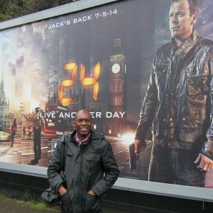 David Olawale Ayinde Actor Standing near a Promotion Poster for the show which currently filmed in London UK