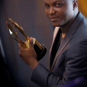 Stanlee Ohikhuare holding up the Award won at the 2014 AMVCA for the DEADWOOD Docudrama