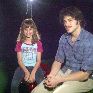 Sydney with director Noah DeBonis during an interview for the film Posthumous in which she portrays a child who cannot hear nor speak