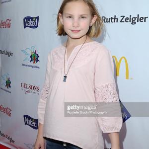 Child actress Camille Schurer arrives at the 17th Annual Day of the Child Carnival presented by Children Uniting Nations at La Brea Tar Pits on November 15, 2015 in Los Angeles, California.