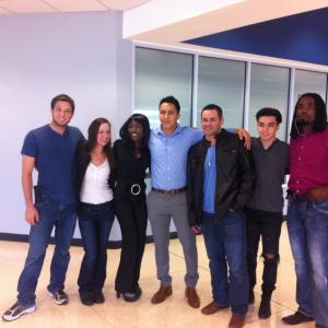 On the Set Location of Siren City Love Field Airport Aaron on the left side Blue tshirt jeans and sneakers