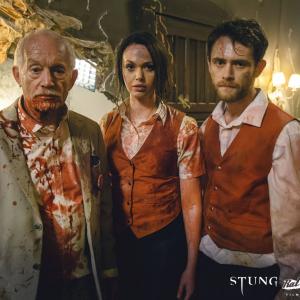 More wasps on the way. Paul (Matt O`Leary), JULIA (Jessica Cook) and MAYOR CARUTHERS (Lance Henriksen) look on...