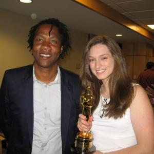 Jasmine Brotzman and Roger Ross Williams share the weight of an Oscar during a leadership seminar lunch at their alma mater