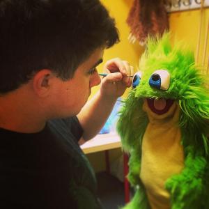 Connor Asher at work inside the Creventive workshop painting the eyes of the Creventive puppet character Jeremy