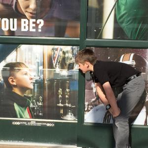 Jack admiring a still photo of himself on the front door of Dicks Sporting Goods (2015)