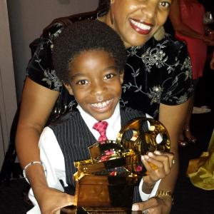 Alexander Arzu and his mom with the NAFCA Oscar Award that his film Successor of Katunga won