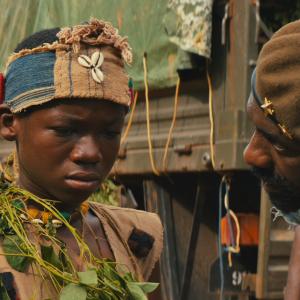 Still of Idris Elba and Abraham Attah in Beasts of No Nation 2015