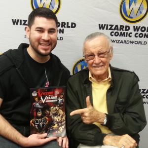Branden Conejo giving a copy of Victims of Villains to Stan Lee
