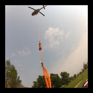 Photo was taken of Garret Kaminskis from 100' below a UH-1NN Huey helicopter from a helmet CAM just before lift off.