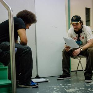 Actor Keyth Williams with Director Josh Hale go through a scene backstage on the set of the film Seat League