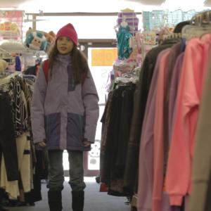 Jalina Mercado standing in the middle of the store. Direct screenshot from the movie 'The Edge of 12'.