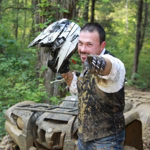 Brian Getting Muddy for Photo Shoot for Dirt Road to Success Promotion