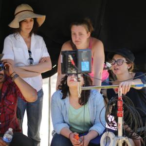 Roe (in pink) as the script supervisor on the set of 