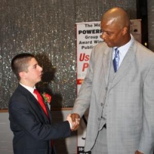 A young Neil A. Carousso (left) is honored with retired Major League Baseball player Darryl Strawberry