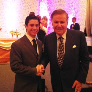 Neil A Carousso shakes hands with Emmy awardwinning journalist Marvin Scott at an event in New York City