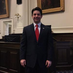 Neil A. Carousso poses in the New Hampshire House Chamber, the largest state House Chamber in the United States.