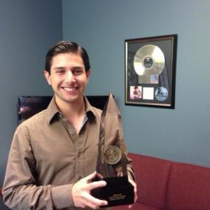 Neil A. Carousso proudly holds WRHU-FM's 2014 Marconi award