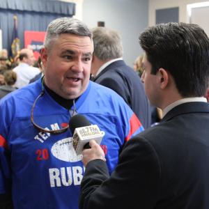 Neil A. Carousso interviews a Marco Rubio campaign volunteer at a Rubio rally in New Hampshire.