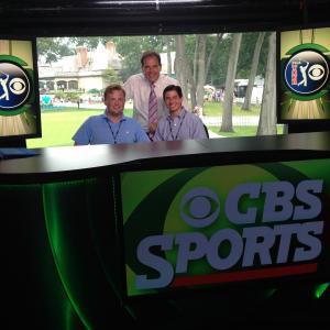 Neil A Carousso right and colleague Rich DeKorte left pose for a picture with Jim Nantz middle in the CBS Sports studio at the 18th hole at The Barclays 2014 PGA Tour event in Paramus NJ