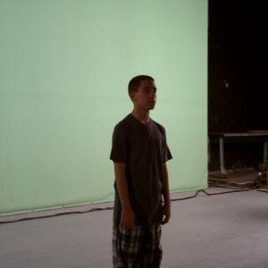 Samuel on set of Birthday Fire in front of the green screen