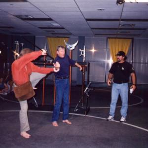 Stunt and fight coordinator Michael Vendrell watches Michael Dawson and Bo Svenson rehearse a fight scene on the Kung Fu The Legend Continues set 1993