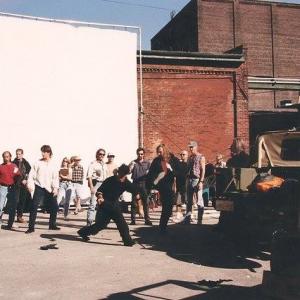 Michael Dawson, Al Leong, David Carradine, Chris Potter - and many other cast and crew members - rehearse a fight scene on location shooting 