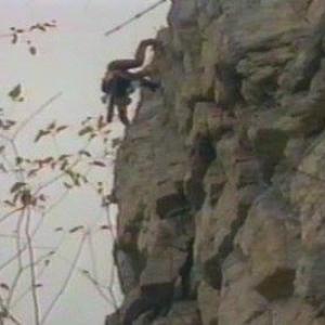 Screenshot of Michael Dawson stunt doubling David Carradine during a spider climb descent on a 100 cliff 1994