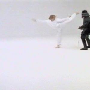 Screenshot of Michael Dawson left dispensing with a left roundhouse kick to the Dark Warrior Layton Morrison a Darth Vaderlike villain on the season 3 Kung Fu The Legend Continues episode Rite Of Passage 1995