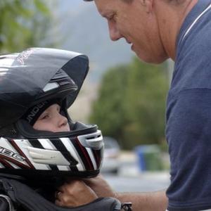 Hudson Morrow gets help with his helmet from his father Chris