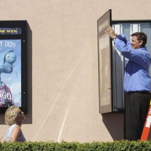 Above, Melanie Morrow and her husband, Christopher, hang posters for Like Dandelion Dust, which will be screened and submitted for consideration during the coming Hollywood awards season.