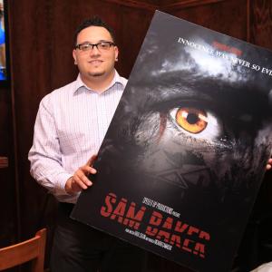 Film Director Raul Colon Holding the poster of Sam Baker Filming begins Summer of 2015