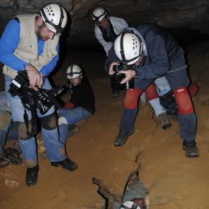 The producers and crew of the TV series Kentucky Life shooting me crawling through a tight squeeze at Mammoth Cave National Park