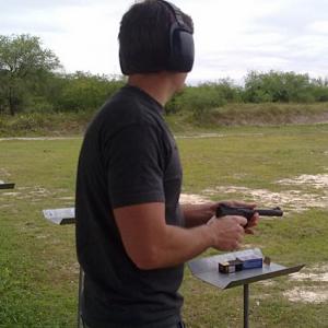 Mike Theiss shooting a gun at the shooting range, one of Mike's hobbies...