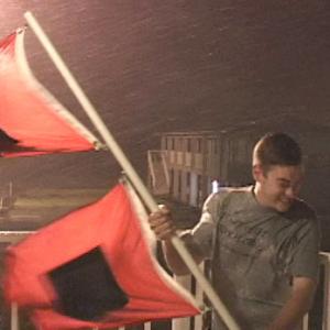 Mike Theiss hanging on to Hurricane Flags in a Hurricane in Florida