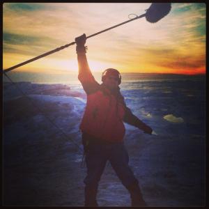 Boomoperating on an ice cliff on Lake Michigan at sunset