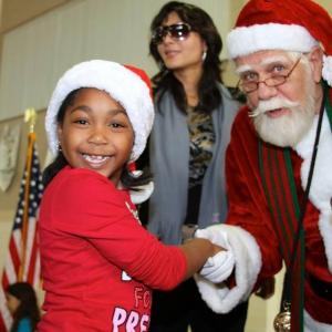 Santa Claus and Jessica Mikayla Adams attends the Loma Alta Park's Festive 7th Annual Celebrity Christmas Toy Giveway